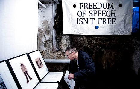 Both inside and outside of the dingy basement location, dueling signs argued the concept of 'free speech'. Photo: Christian Liliendahl/Scanpix
