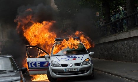 American charged over police car attack in Paris protests