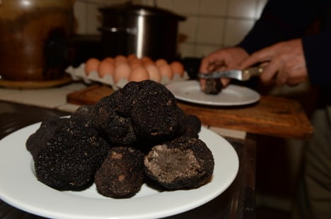 A restaurant owner prepares black Perigord's truffles after a truffle market in Vergt. Photo: AFP