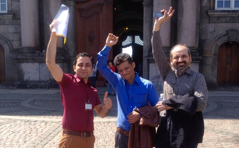 (L-R) Green card holders Naqeeb Khan, Razaul Karim and Nadeem Malik celebrate their victory outside of Christiansborg. Photo: Submitted