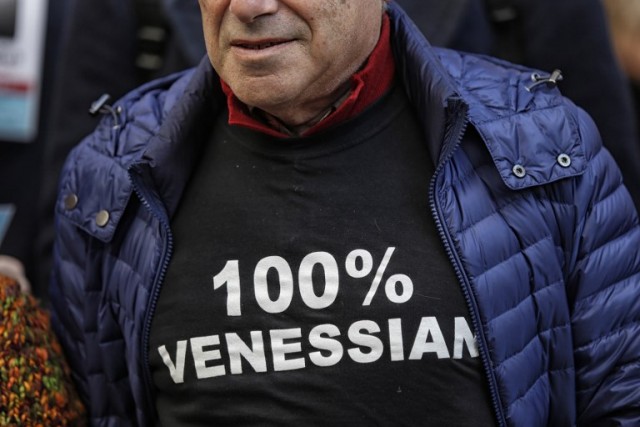 A man wearing a tee-shirt reading ''100% Venetian''. Photo: Marco Bertorello/AFP