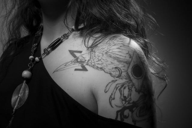 Laura Leveque, 32, who was at the Bataclan concert hall on November 13, 2015, shows her tattoo - a raven, an eclipse and a snake biting its tail. Photo: Joel Saget/AFP