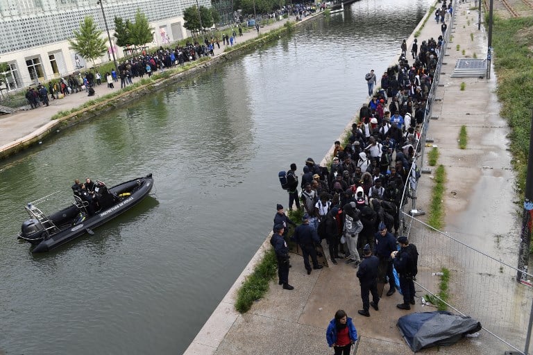 In Pictures: Paris police clear out 1,700 migrants from canal camp 