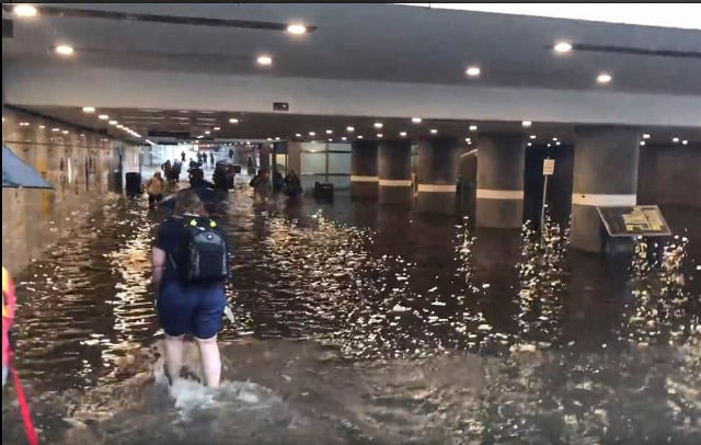 IN PICTURES: Swedes go for a swim in rail station underpass after torrential rain caused floods