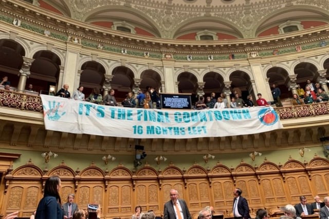 Singing climate activists disrupt Swiss parliament