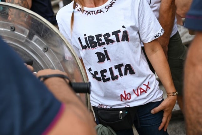 A 'no vax' protestor wearing a t-shirt reading 