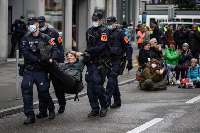 Police detain a demonstrator affiliated Extinction Rebellion (XR) during a protest in center of Zurich 