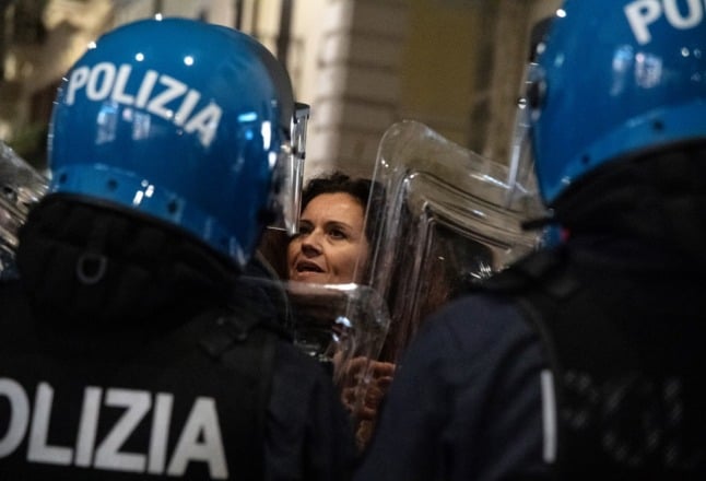 Italian riot police surround protesters in a bid to contain demonstrations which saw one group try to storm the Prime Minister's office.