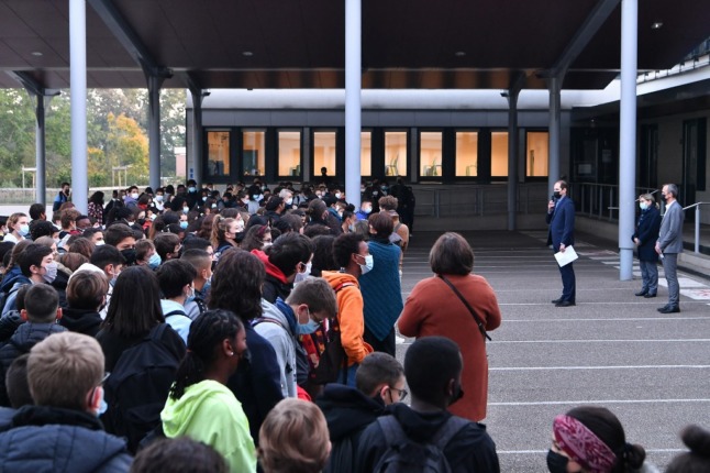 Students and professors gather in the courtyard of Les Battieres college in Lyon on October 15th, 2021 for an homage to French teacher Samuel Paty