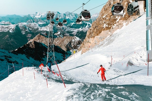 Cable cars and skiers in Austria