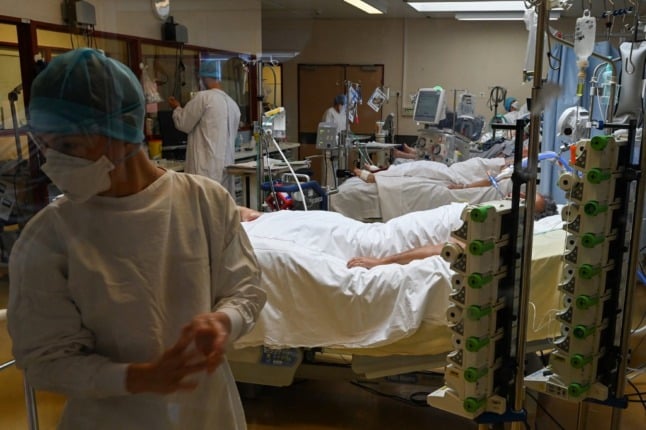 French medical staff in masks and gowns provide medical assistance to patients at a Covid-19 intensive care unit at the Montpellier University Hospital. 