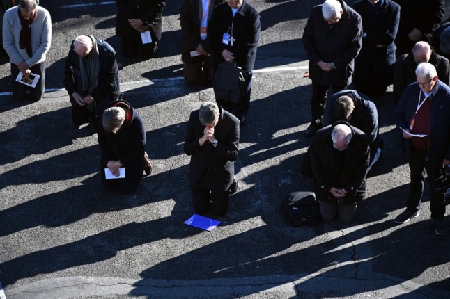 French Catholic bishops kneel in penance at Lourdes