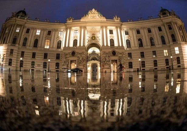 A cyclist passes Hofburg palace at Michaeler square in Vienna, Austria on November 22, 2021. - Austria has entered a nationwide lockdown in an effort to contain spiraling coronavirus infections. (Photo by JOE KLAMAR / AFP)