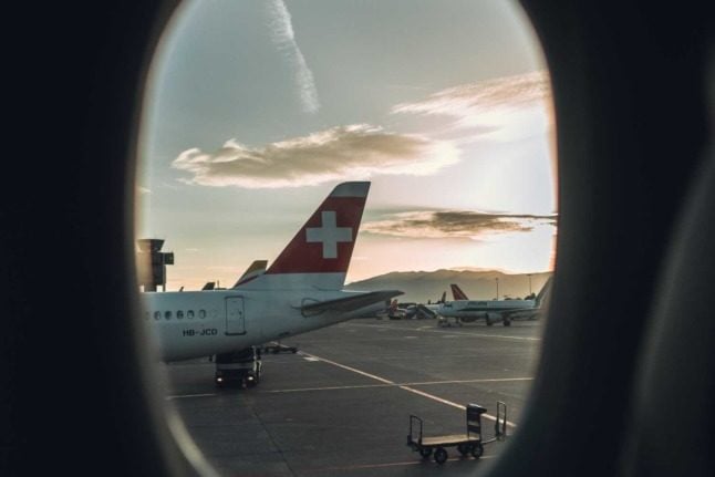 A Swiss airlines plane seen through an airline window