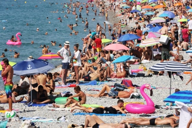 People relax on the beach in the French city of Nice. 