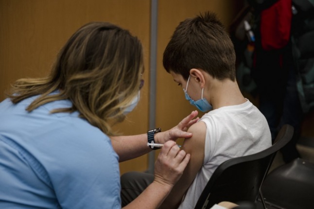 A child, aged 11, receiving a Covid-19 vaccine