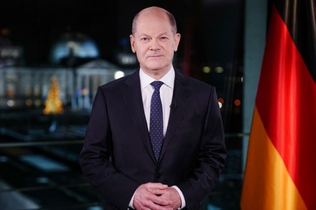 German Chancellor Olaf Scholz poses for photographs during the recording of his New Year's speech at the Chancellery in Berlin, Germany
