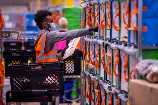 An Amazon worker sorts parcels