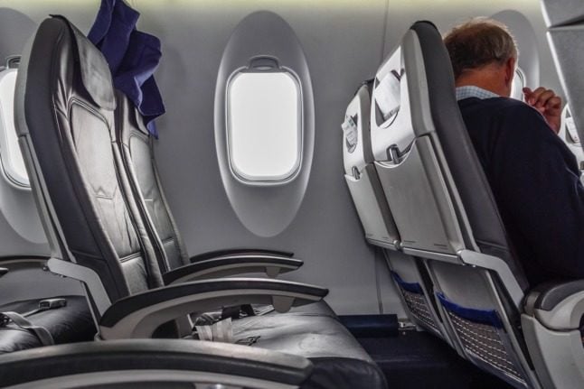 Pictured is a row of seats on a plane. 