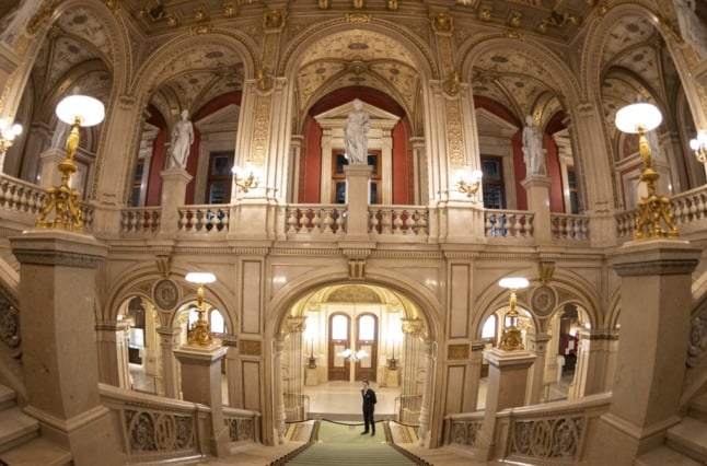 An usher waits for guests prior to a concert at Vienna's State Opera in Vienna, Austria