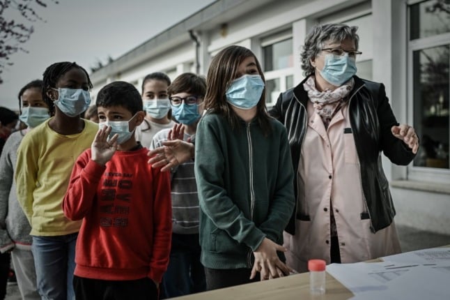 School children wait for a saliva test at a school in southwest France. 