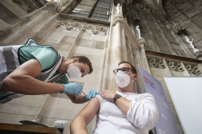 A man receives a vaccine in an old church in the city of Vienna
