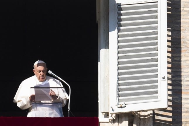 Pope Francis addresses the crowd from the window of the Apostolic Palace overlooking Saint Peter's Square