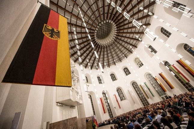 The German flag hangs on the wall during the naturalisation ceremony for more than 2,500 people at the Paulskirche church in Frankfurt 